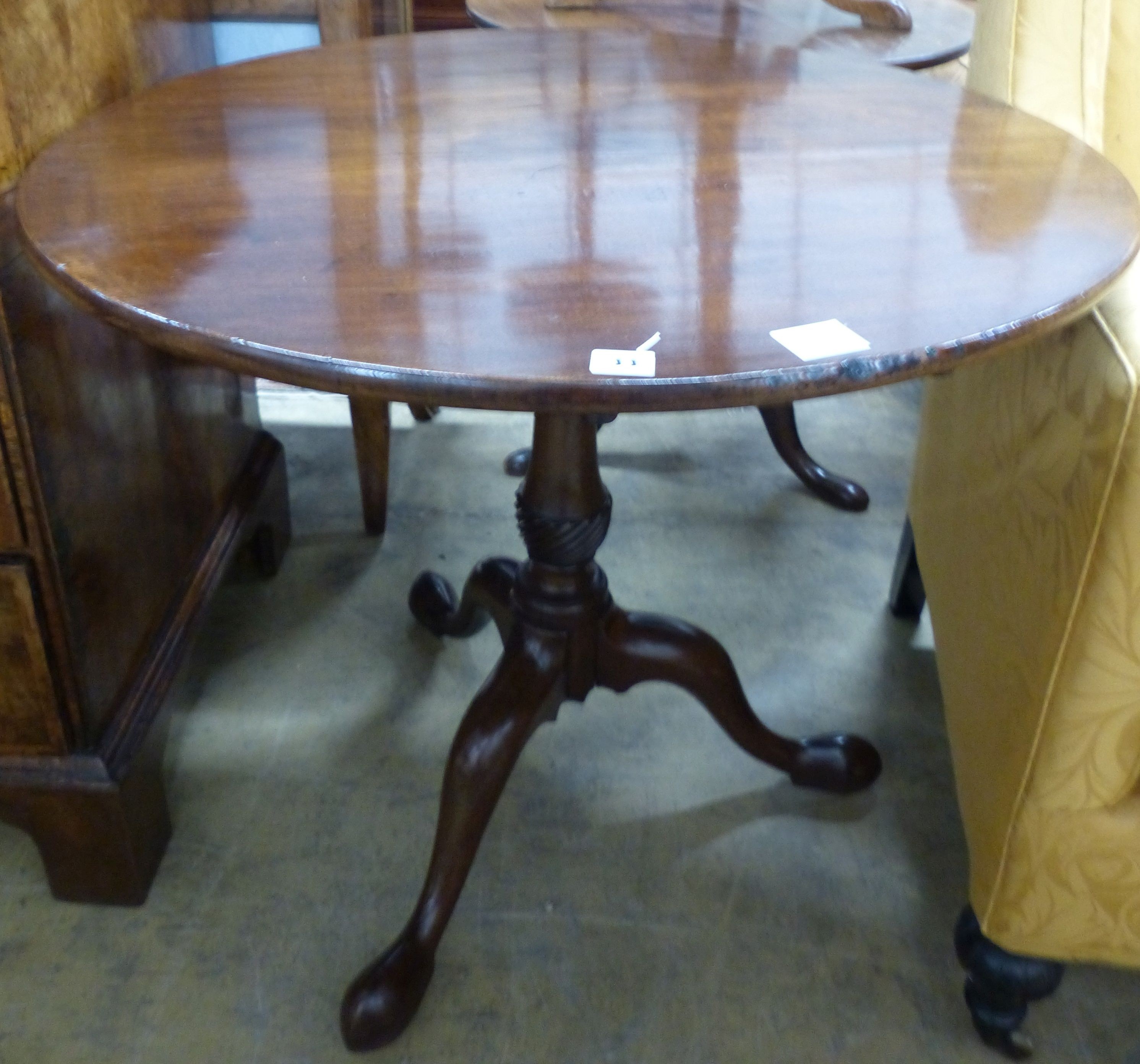 A George III mahogany birdcage tea table, with circular tilt top on wrythen fluted stem, Diam.83cm H.73cm